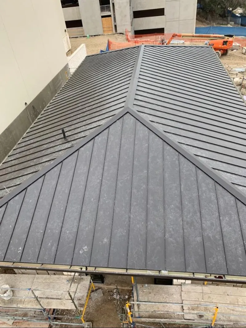 Commercial metal roof construction with crane equipment in Jefferson Hills